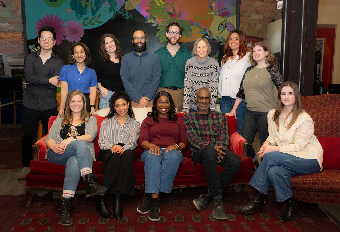 A group photo of 13 members of the Tapestry Community Capital team. 