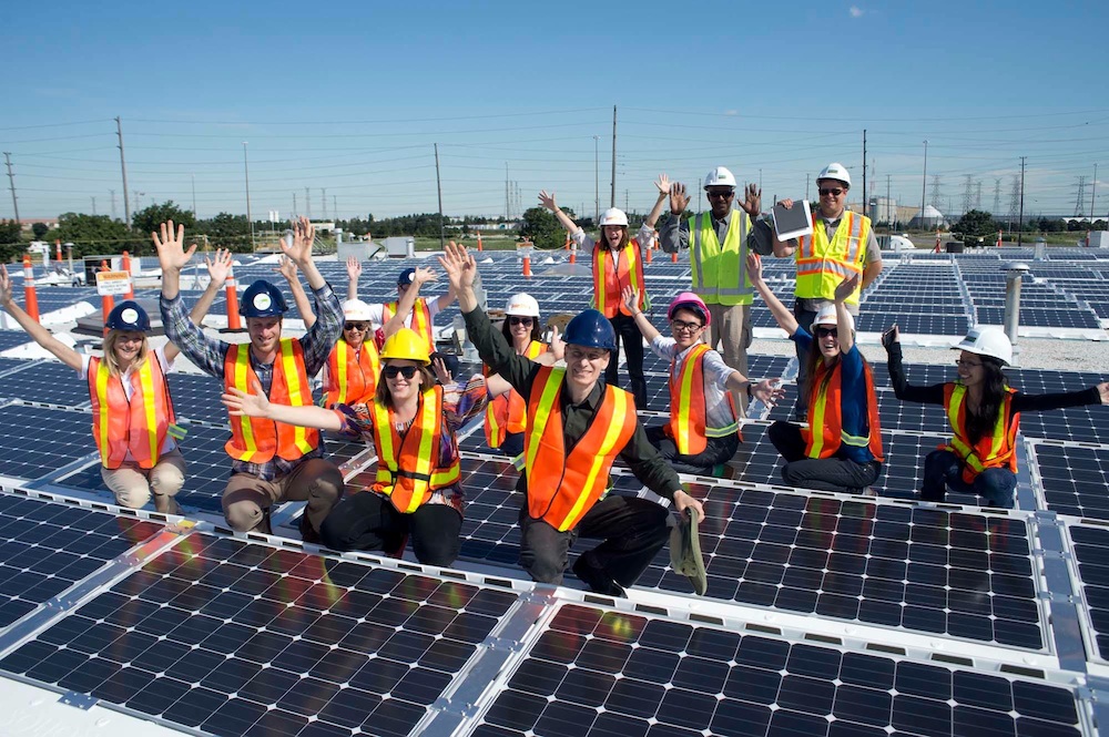 People sitting on large solar panels