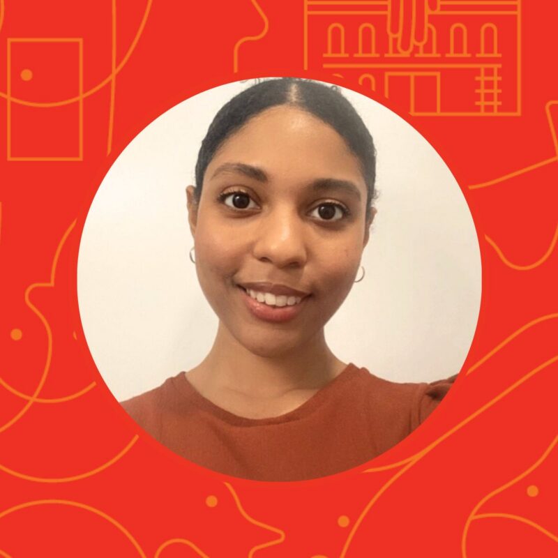 Smiling woman with dark hair pulled back, wearing a rust-colored top, on a red graphic background.