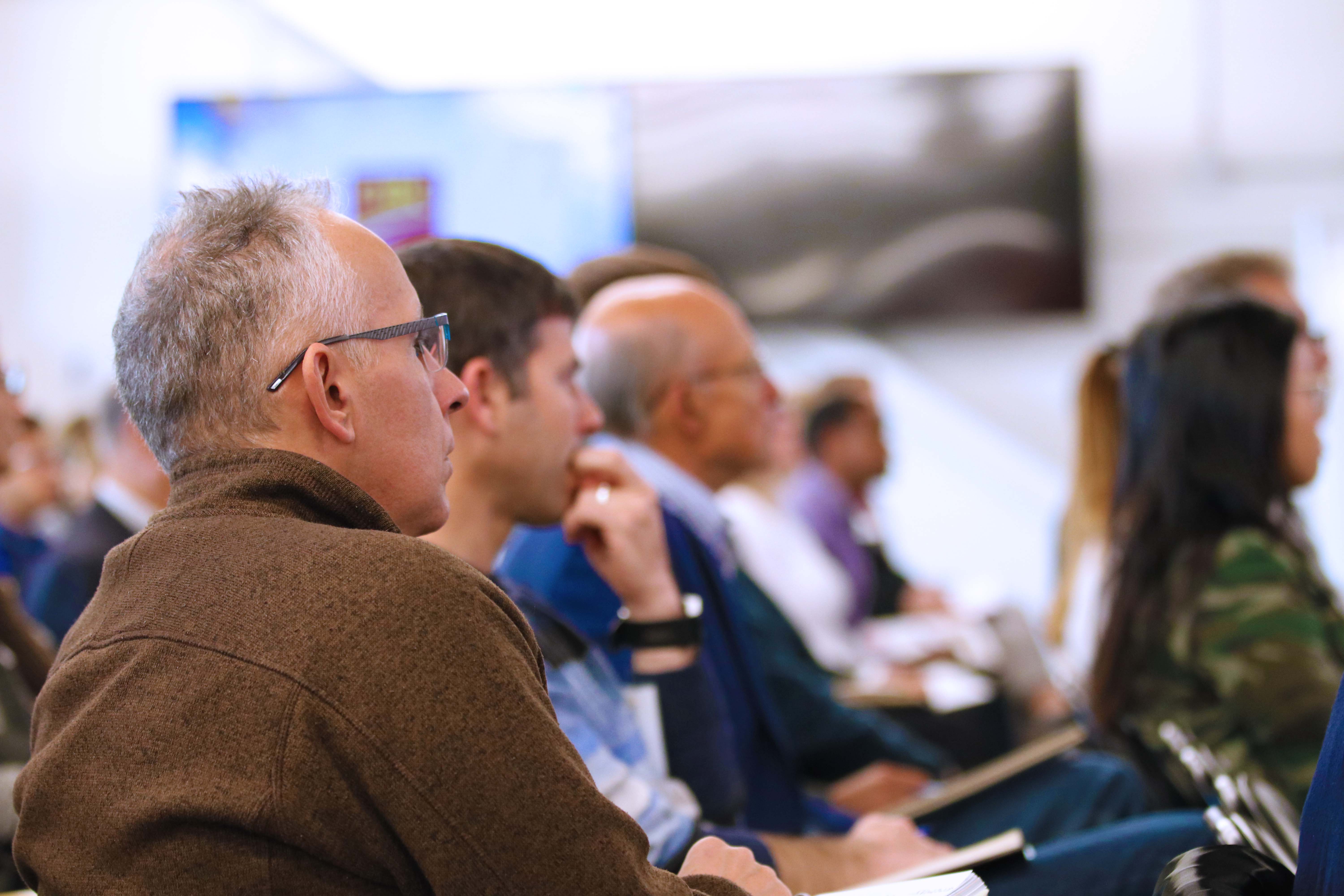 Group of people watching a presentation