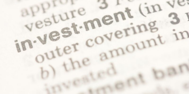 The word Investment Readiness Program in bold text on a dictionary page, surrounded by definitions and words.